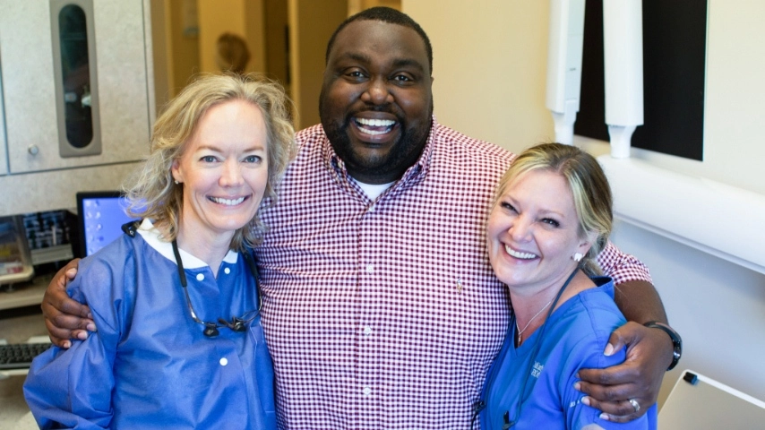 Smiling-happy-patient-with-dentists